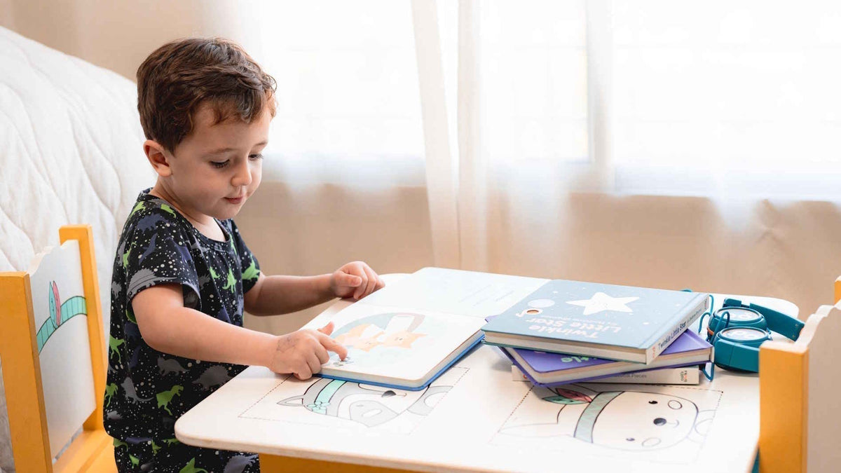Child sitting at a table and reading