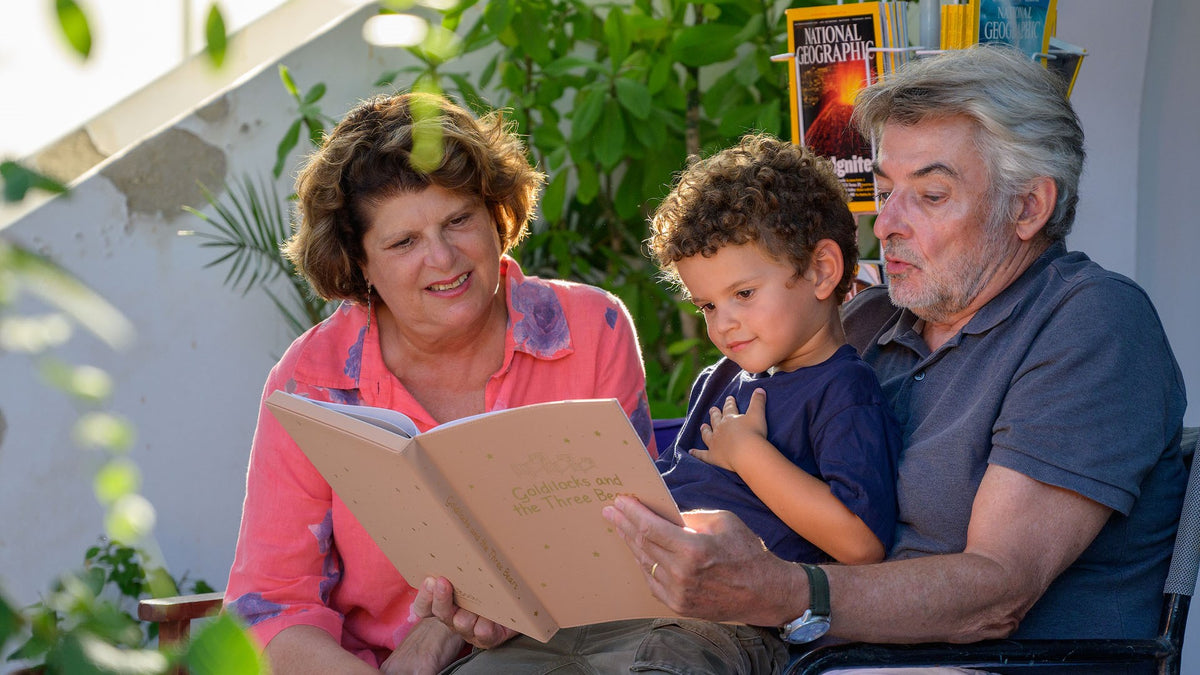 Grandparents are reading a book to their grandson. Kids fun activity, recordable books for grandparents.