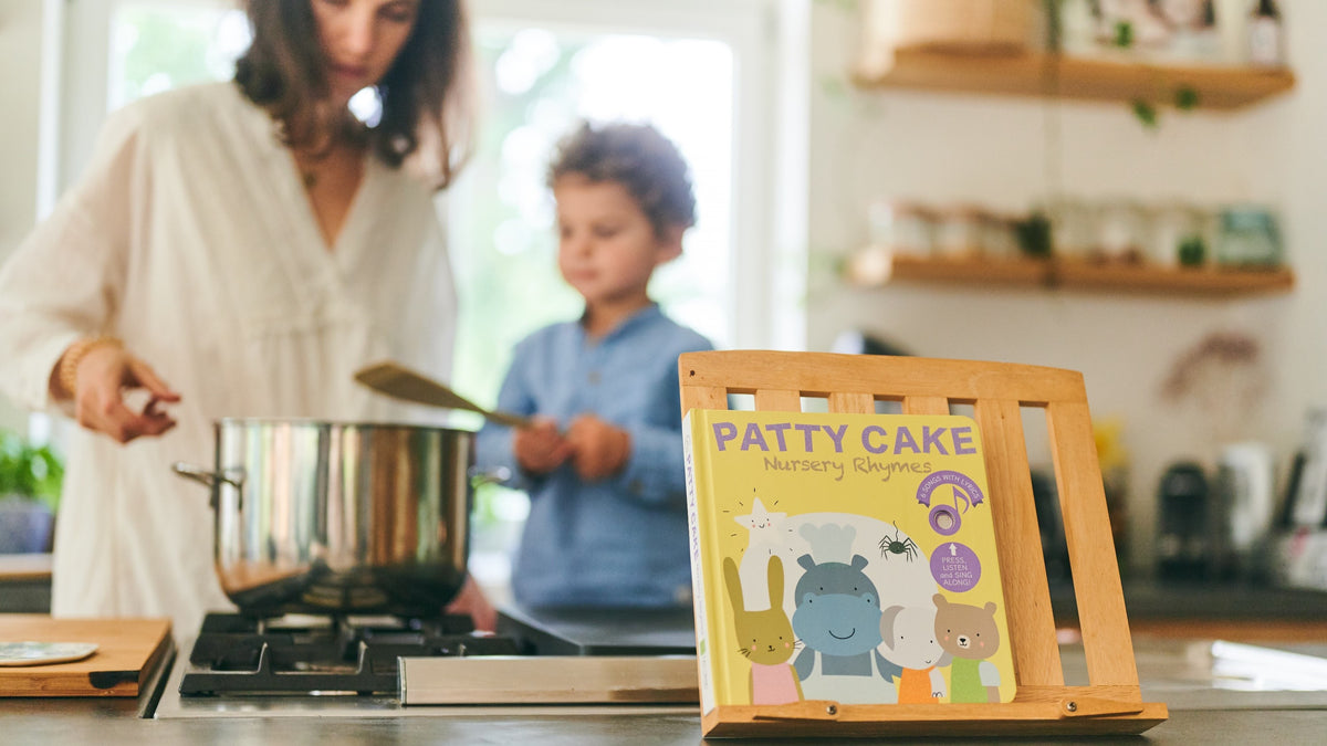 A Mom is reading and cooking with her young son. Children books, fun activities, educational.
